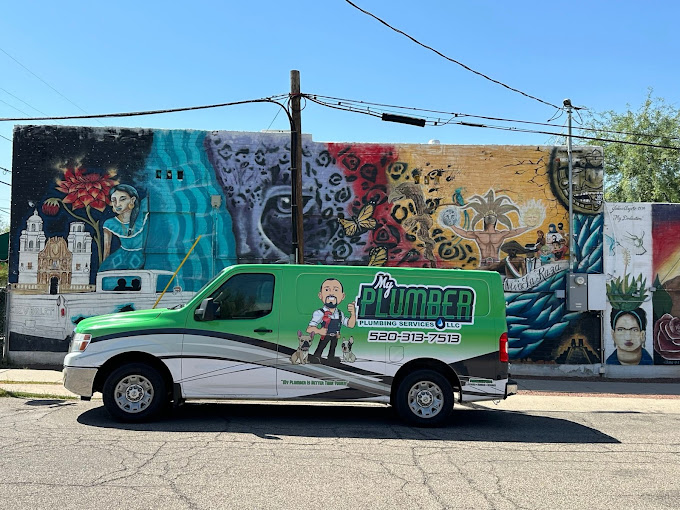 My Plumber Plumbing Services green van — the green ribbon stands for mental health awareness, parked on a Tucson street